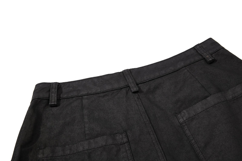 Close-up of black back waistband and pocket top stitching on cargo shorts