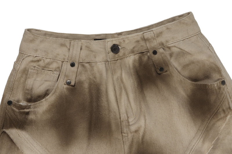 Close-up of khaki pants waistband with button closure, belt loops, and faded distressed texture