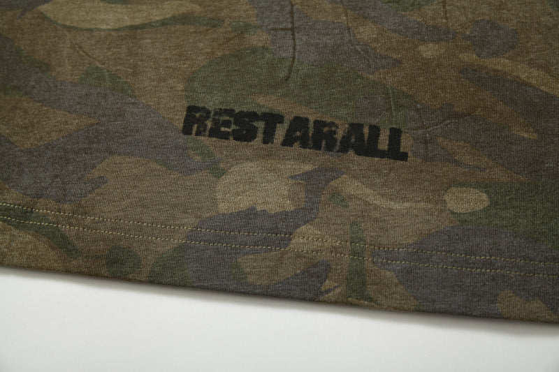 Close-up of back hem print reading RESTARALL on camo long sleeve tee