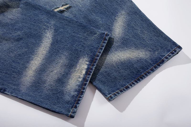 Cuffed denim hem on wide-leg jeans with faded blue wash
