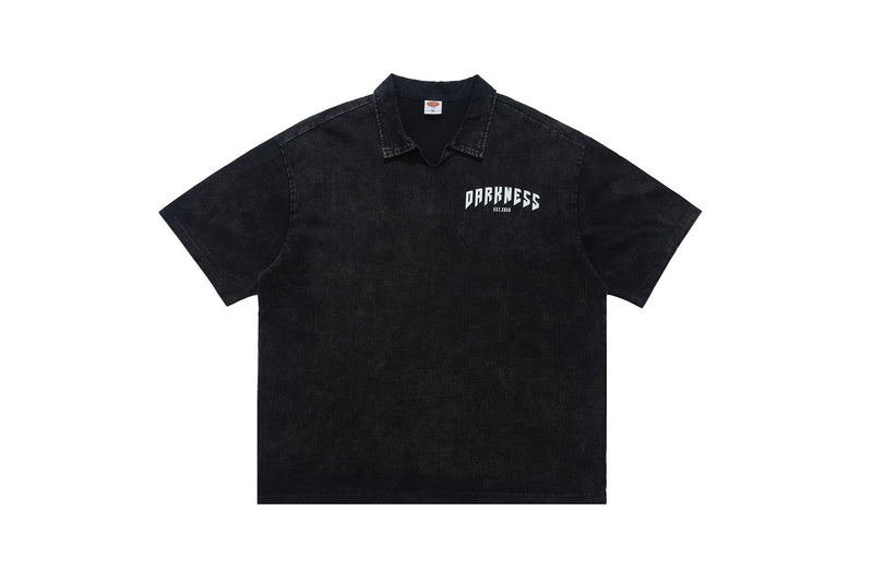 Black washed polo shirt with a small Darkness logo on the chest and a relaxed short-sleeve fit