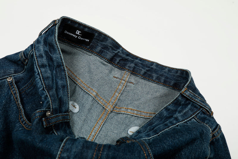 Inside waistband view of deep indigo jeans with light gray pocket lining