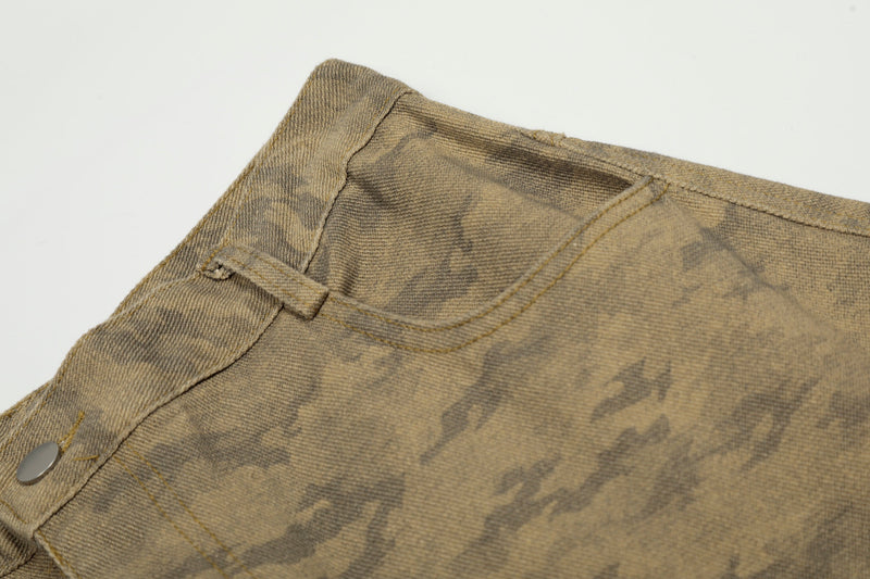 Close-up of front pocket and waistband seam on desert camo cargo jeans