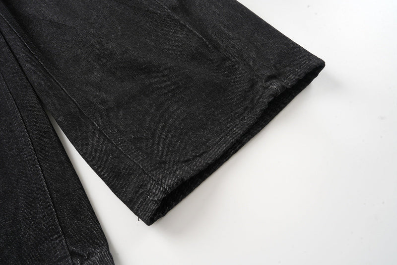 Wide-leg black denim pant hem with stitched cuff