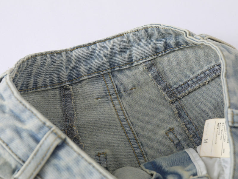 Inside waistband close-up showing seam stitching and care label on denim jeans