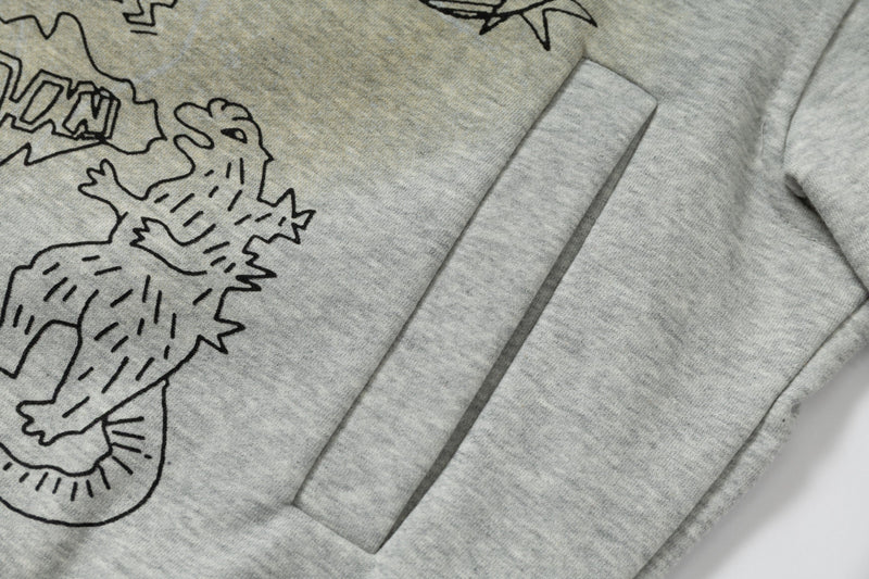 Close-up of front pocket and lower graphic on grey zip hoodie