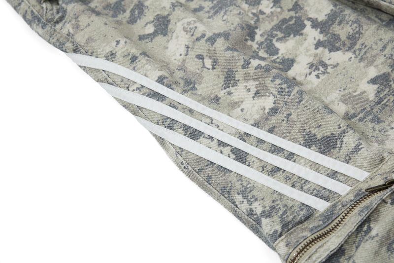 Close-up of reflective side stripes and zipper pocket on camo cargo pants