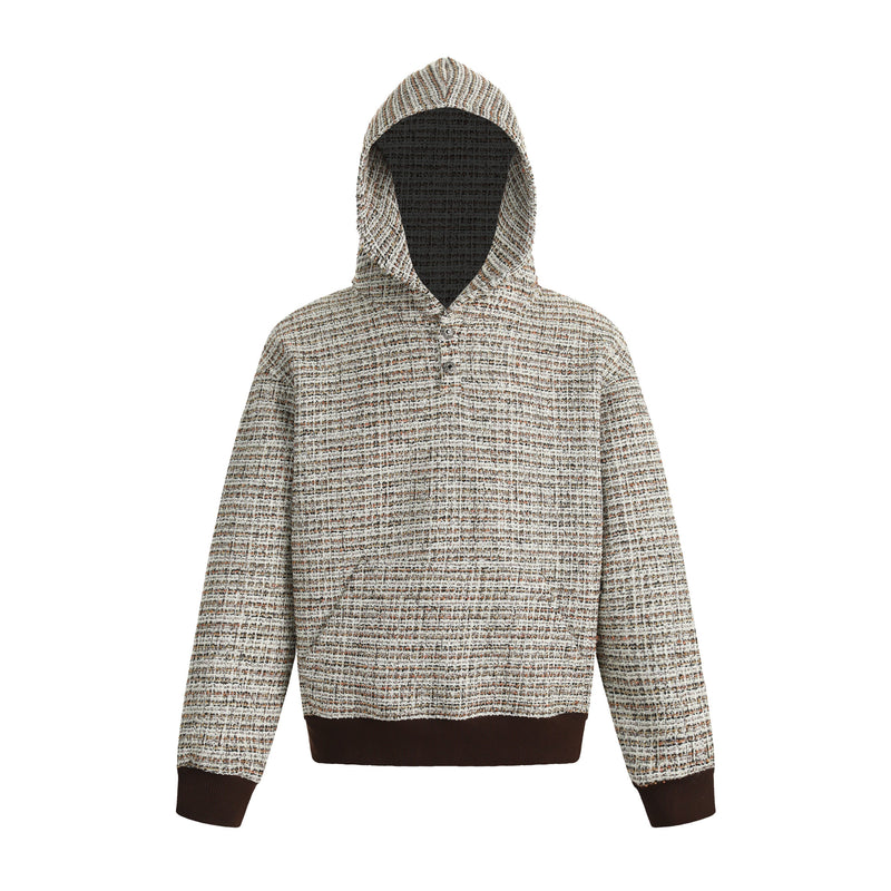 Front view of a textured boucle knit hoodie with brown ribbed cuffs and hem