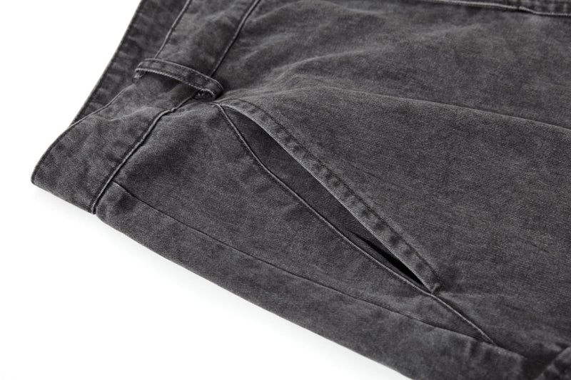 Close-up of wide leg hem and cargo pocket on washed black pants
