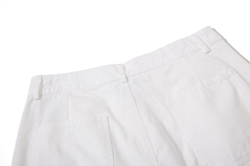 White shorts back pocket and waistband detail, close-up