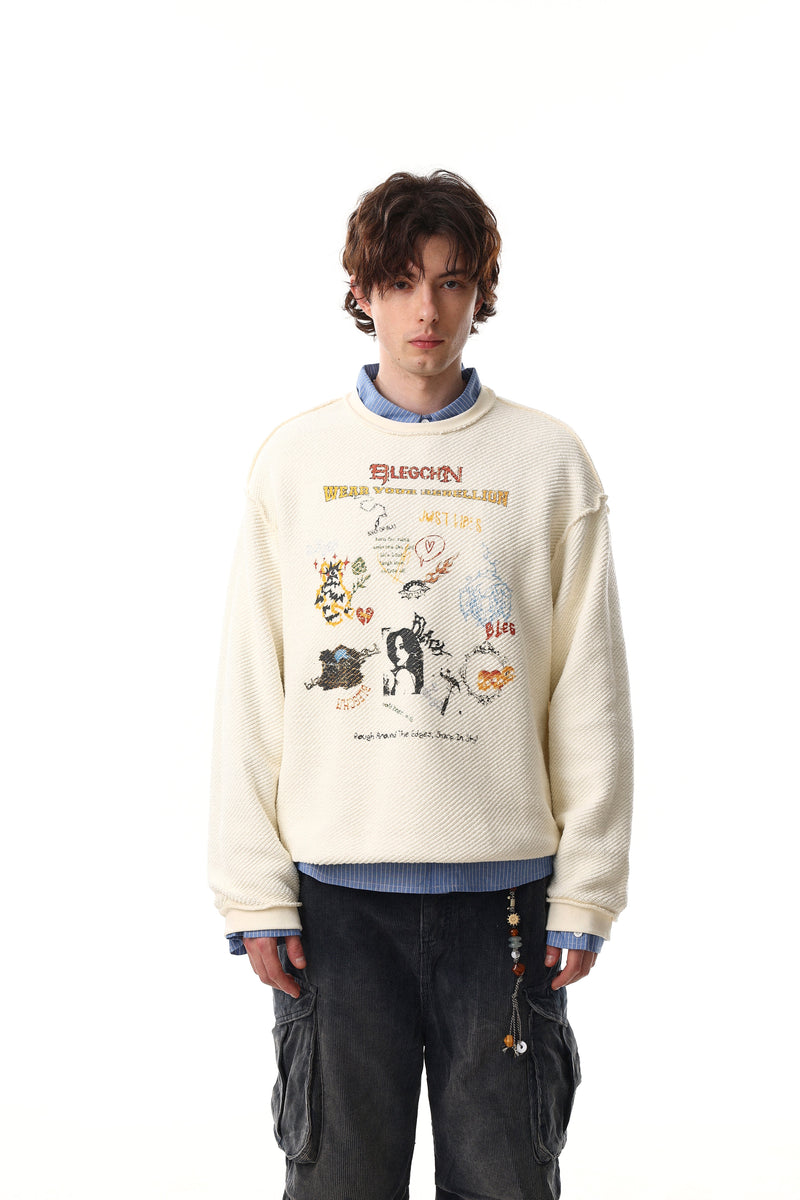 Model wearing cream collage graphic sweatshirt over a blue shirt