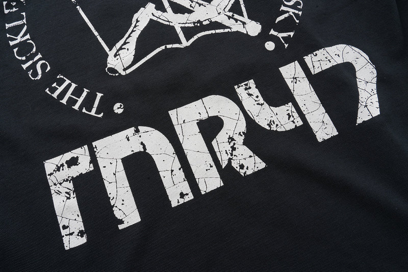Black shirt back close-up showing large cracked white THRU print