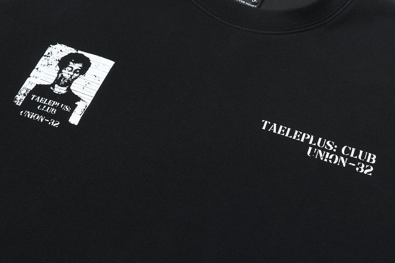 Close-up of black tee front with portrait graphic and TAELEPLUS CLUB text