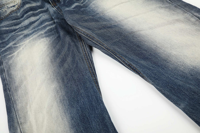 Close-up of wide-leg denim lower section with faded wash and seam detail