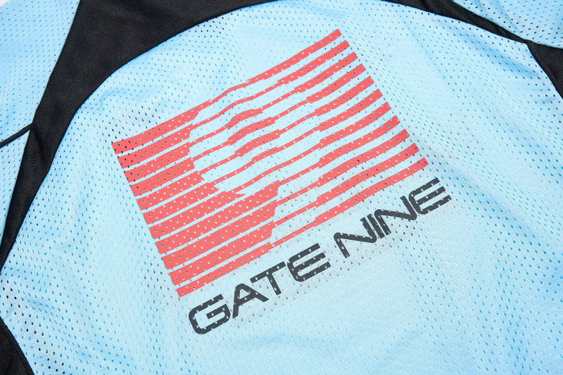 Light blue mesh sports jersey with black panels and red graphic stripe logo reading Gate Nine