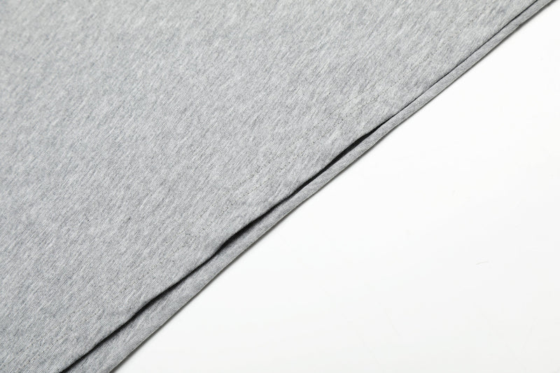 Gray shirt hem close-up with side seam stitching