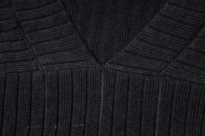 Close-up of V-neck and ribbed knit texture on the black sweater