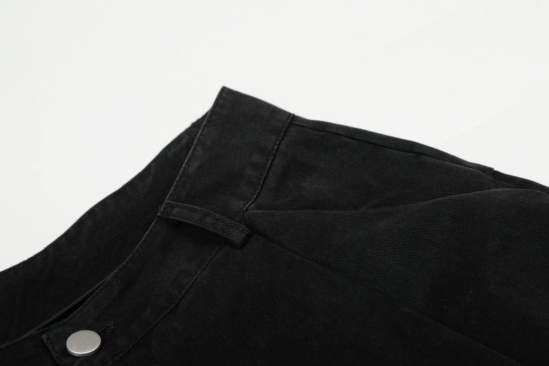 Close-up of black pants waistband and top seam with belt loop detail