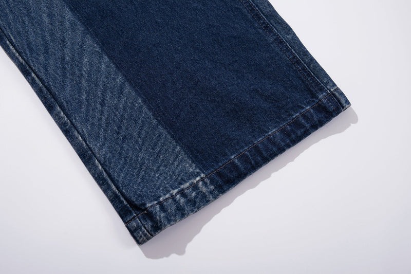 Close-up of hem on wide-leg blue denim jeans