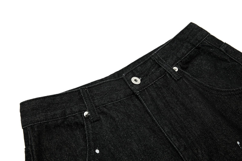 Close-up of black jeans waistband with button closure and belt loops