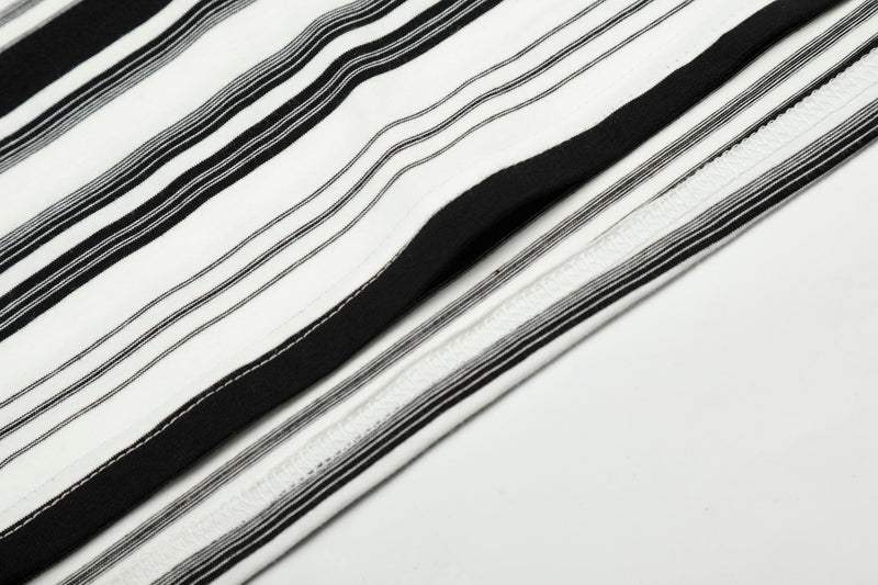 Close-up of black and white striped fabric showing printed stripes and seam stitching
