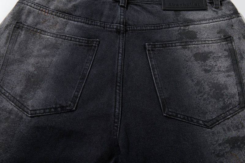 Back view close-up of the waistband and patch pockets on dark washed wide-leg jeans