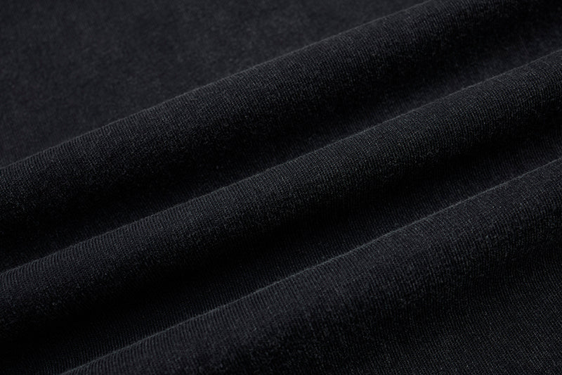 Close-up of black distressed fabric with ribbed texture for a gothic punk sleeveless T-shirt