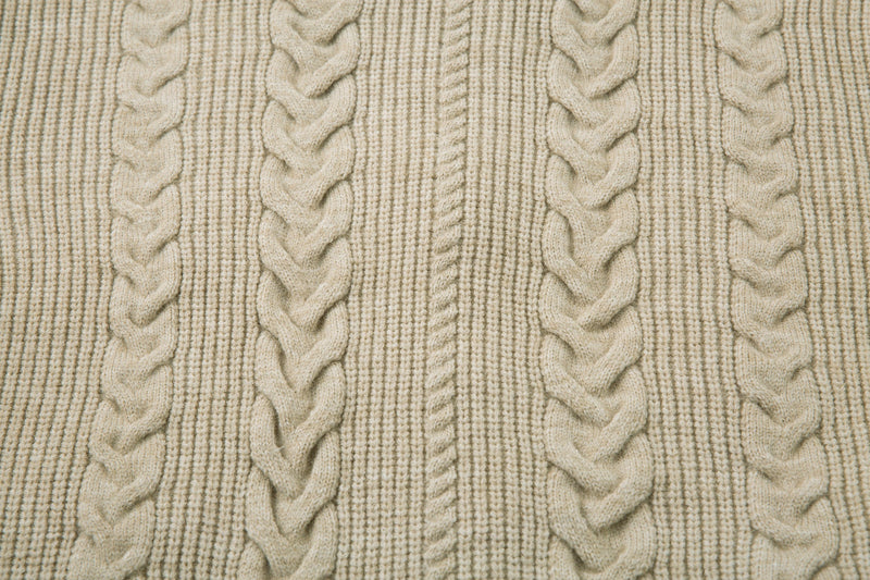 Close-up of beige cable knit pattern on sweater jacket body