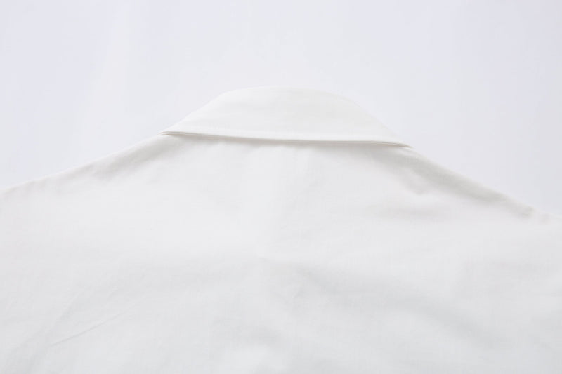 Close-up of white shirt collar and upper back seam
