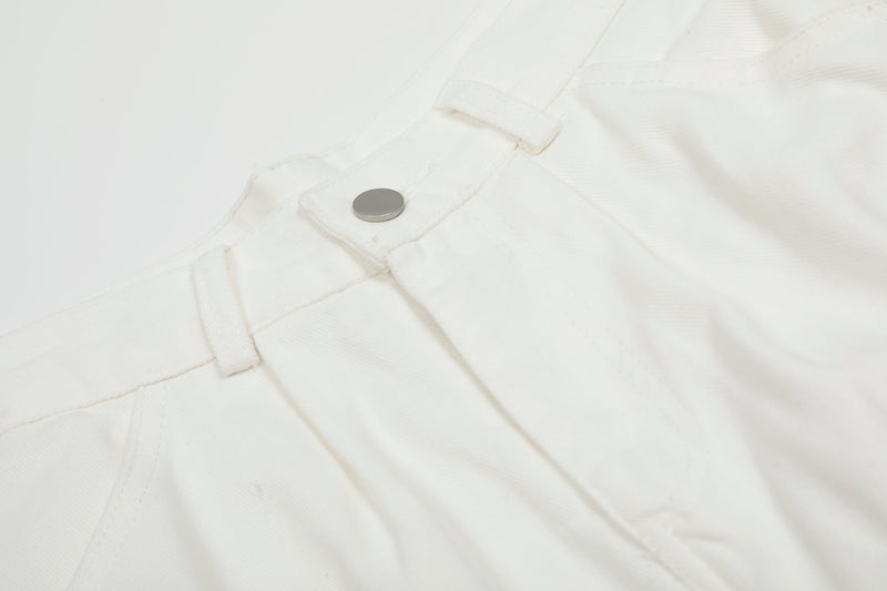 Close-up of white cargo shorts waistband button and seam detail