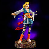 The Seakoff Android 18 Collectible Figure from Dragon Ball Z, standing at 26cm, features a blonde anime character in a blue kimono with gray patterns, striking a samurai pose. Sheathed sword in hand, orange leg warmers, and a red belt with a mask accentuate her style against the vibrant purple backdrop.