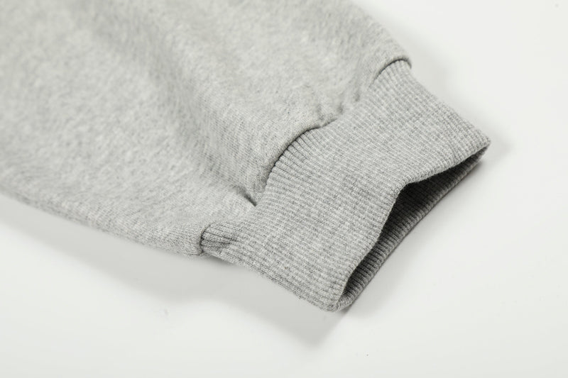 Close-up of light gray hoodie cuff with ribbed knit trim