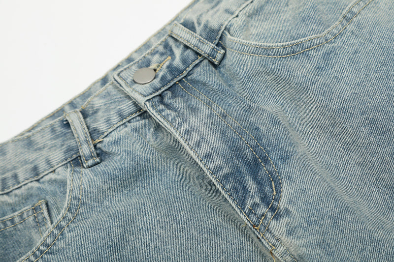 Light wash denim front pocket and seam detail with metal snap
