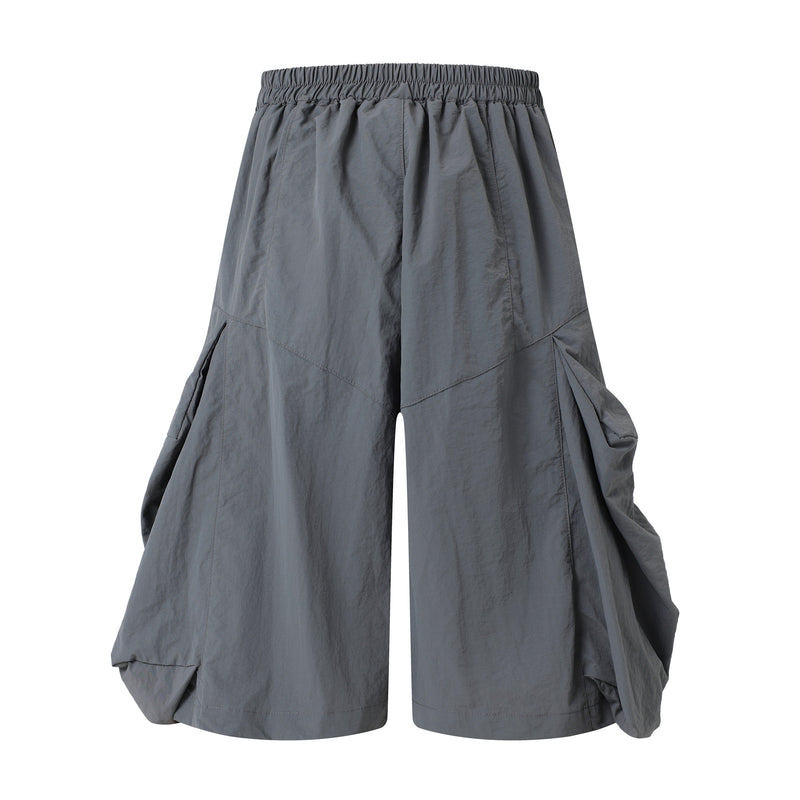 Gray wide-leg shorts, back view with gathered elastic waistband and draped side volume