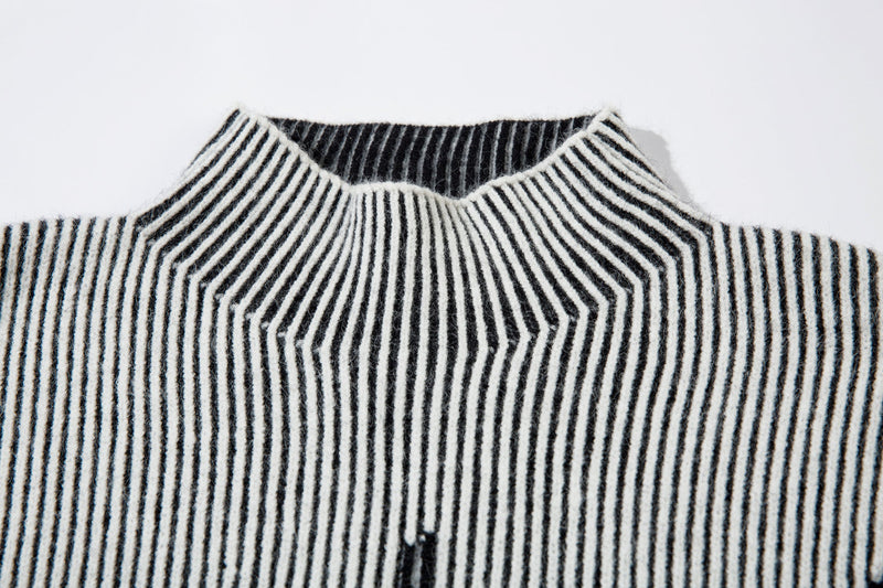 Front view of white ribbed knit sweater with black lightning graphic