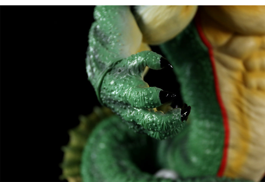 A close-up of a Seakoff Shenron Broly Collectible Figure reveals a detailed green reptilian claw with black nails, bumpy skin texture against a black background, and vibrant hints of red and yellow evoking Dragon Ball Z&