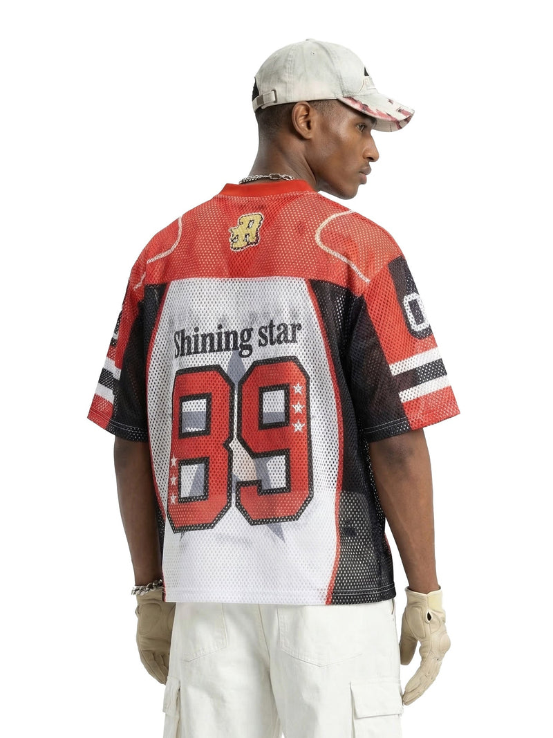 Red mesh football jersey T-shirt with Shining Star 89 graphic, worn by a model in a streetwear look