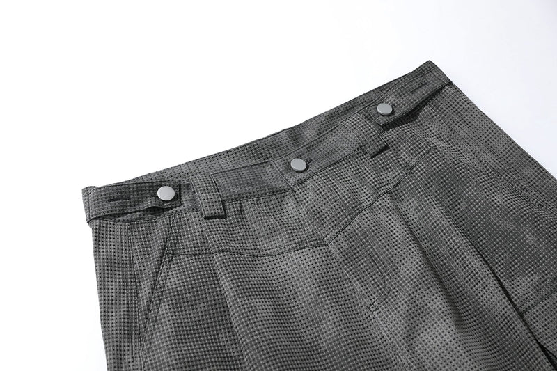 Close-up of black mesh shorts waistband with snap buttons and belt loops