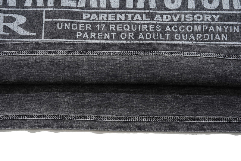 Vintage washed black graphic tee with faded parental advisory print and raw hem detail