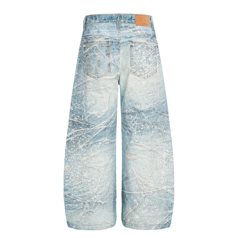 Back view of light blue wide-leg jeans with spiderweb wash and tan leather patch at waistband