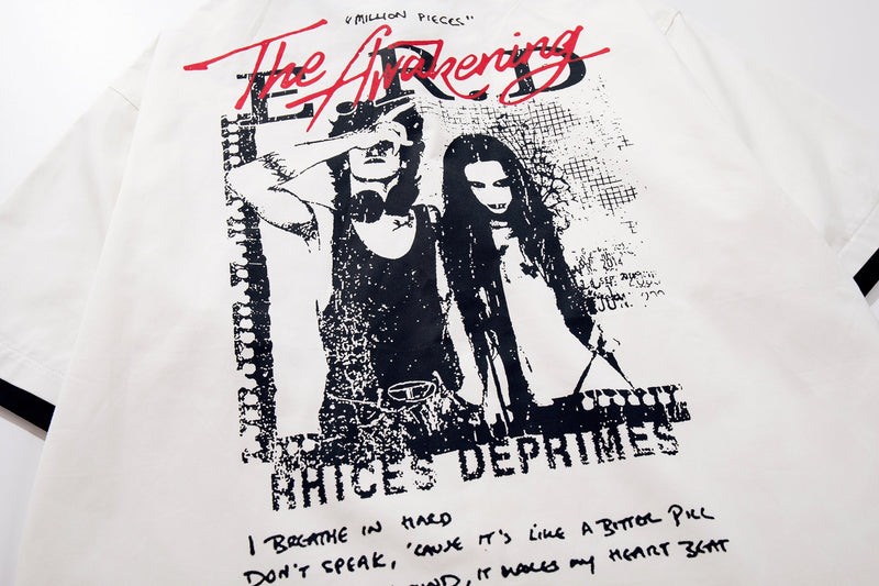 White oversized graphic T-shirt with black punk-style artwork and red The Awakening lettering on the chest