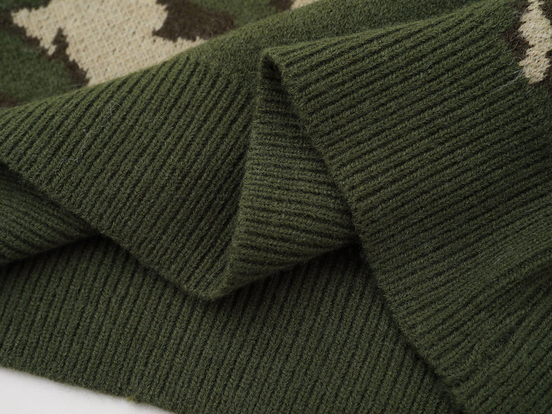 Close-up of ribbed green knit hem and sleeve details on the sweater