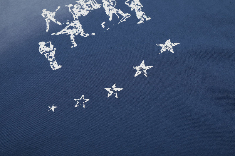 Blue washed cotton tee with faded white star graphics and distressed graphic print detail