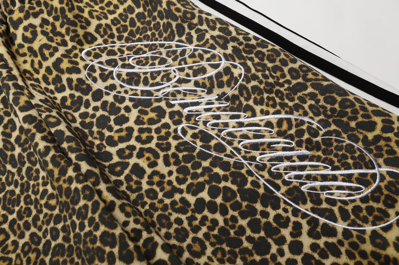 Close-up of leopard print front graphic with white embroidered script
