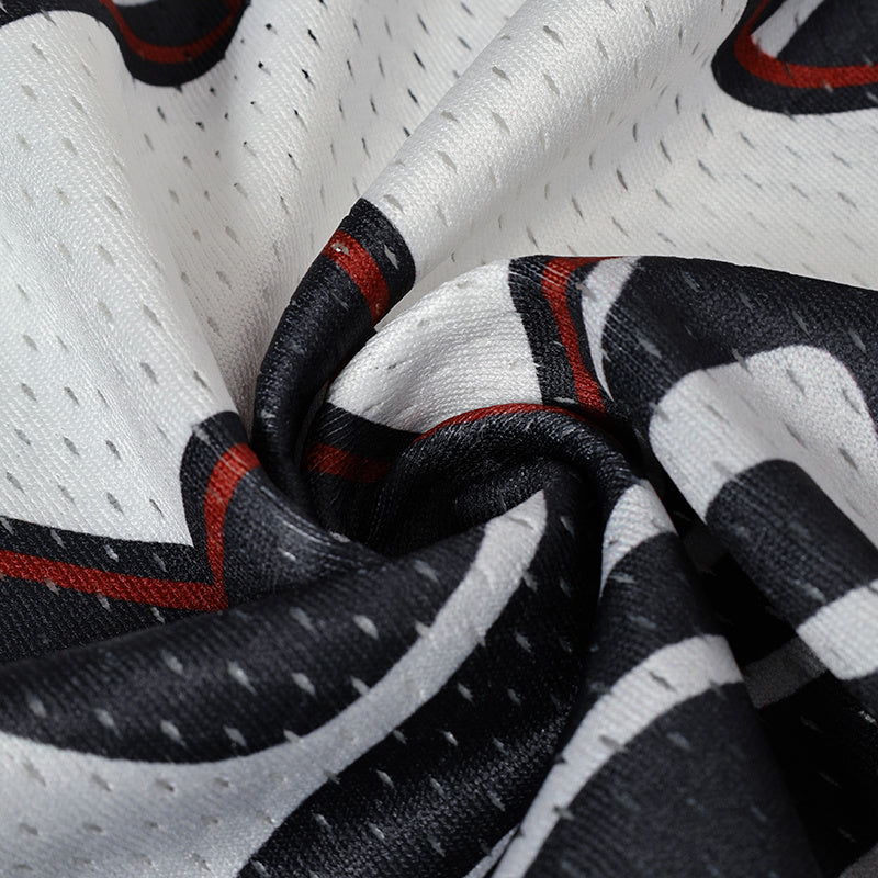 Close-up of white mesh football jersey fabric with black swirl camo and red accents, featuring number 24 graphics