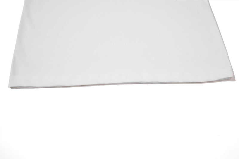 White polo tee hem with clean straight stitching and lightweight streetwear style