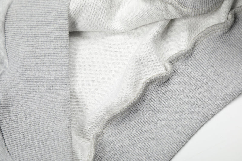 Close-up of light gray hoodie interior fleece lining and ribbed trim