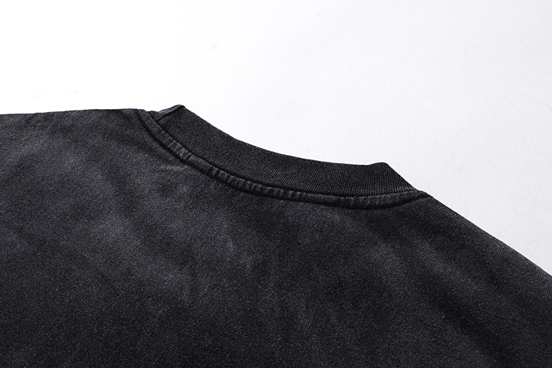 Close-up of black washed tee neckline with ribbed crew neck detail