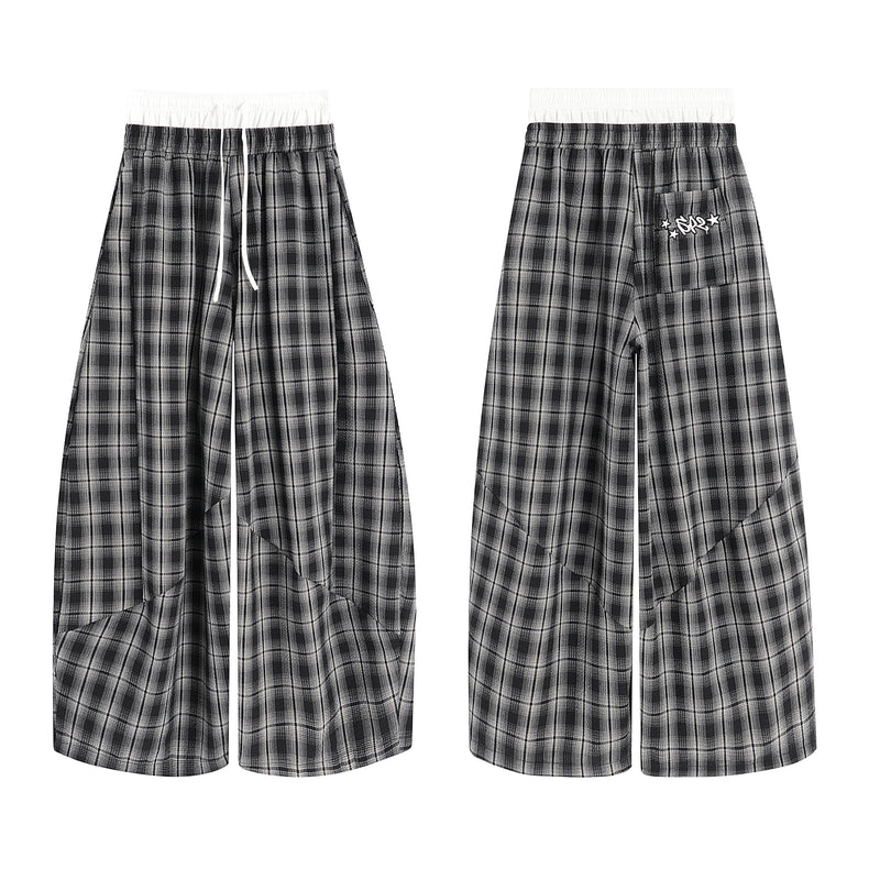 Front and back view of black and grey plaid wide-leg track pants with white elastic waistband and drawstring