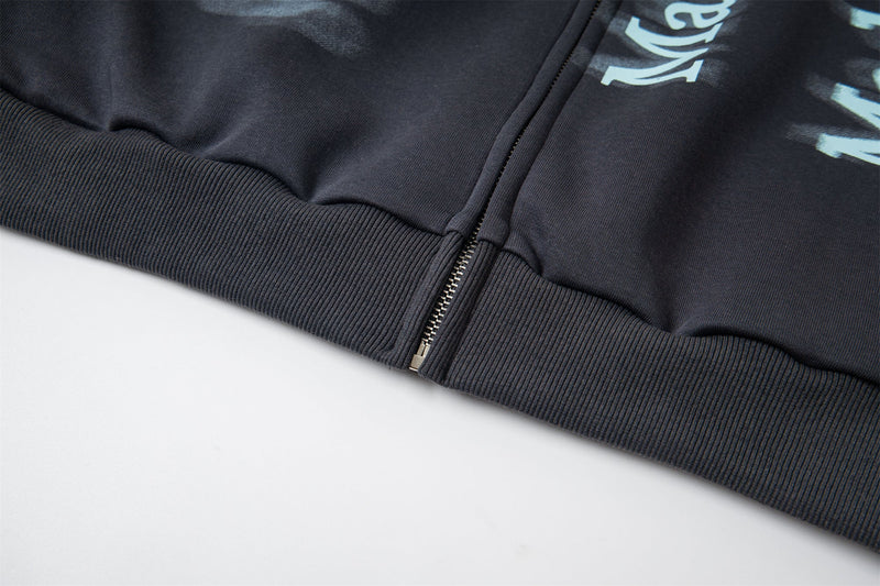 Close-up of ribbed hem and zipper on black hoodie front